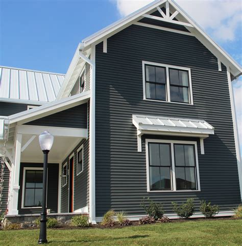 grey house with white metal roof|gray siding black windows.